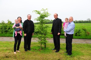 Local priest and minister with Rohan family planting a tree on memory of Liam Rohan