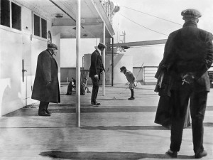 Robert Douglas Spedden, watched by his father Frederic is playing on deck n the Titanic with a spinning top. Image: Fr Frank Browne (1912)