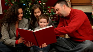 stock-footage-family-reading-a-book-at-christmas-time