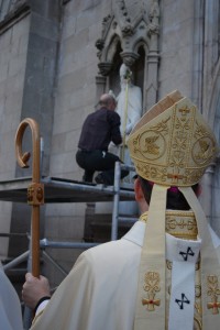 Archbishop Eamon Martin, wearing the pallium, watches on as the statue of St Patrick on the front of St Patrick's Cathedral in Armagh is refitted with a crozier.