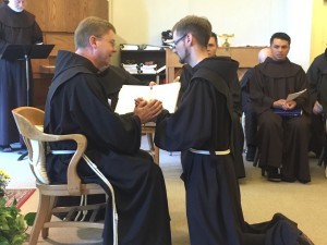 Br Denis Aherne OFM places his hands into the hands of the Provincial Minister of the Irish Franciscans, Friar Hugh McKenna OFM as he makes his 1st Profession of Vows. 