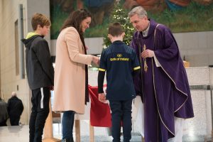 18/12/2016 The family of Anthony Foley his wife Olive and her sons Tony, 11 and Dan, 8 present a Munster Rugby Jersey to Fr. Richard Gibbons, at Knock Shrine, Knock, Co. Mayo. Photo : Keith Heneghan / Phocus